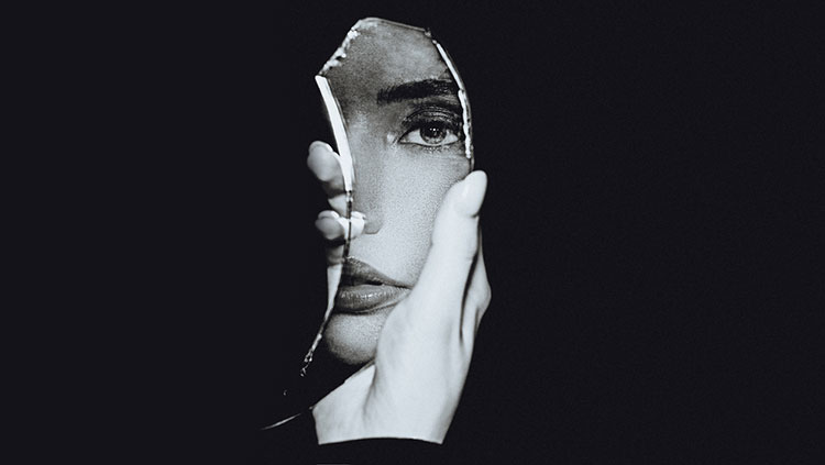 Woman holding a piece of mirror