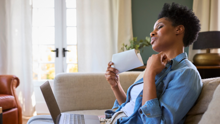 Woman fanning herself with paper