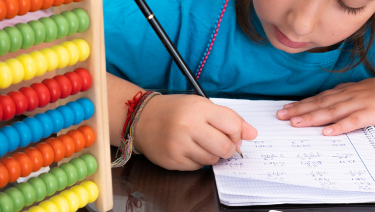 Little girl writing on paper