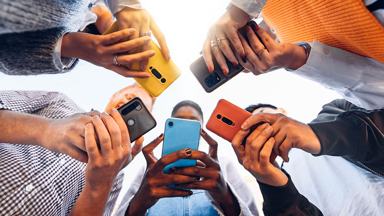 People standing in a circle with their phones