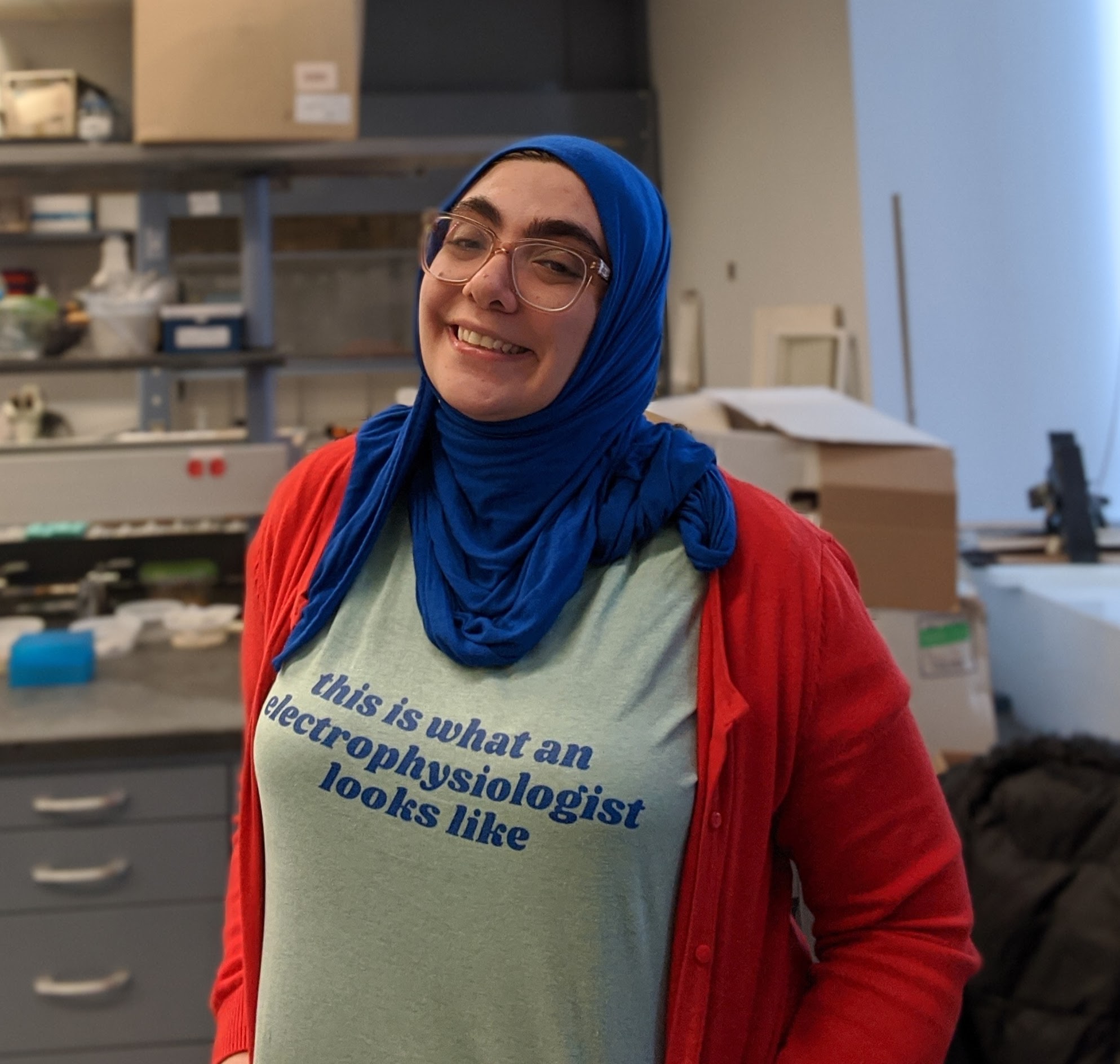 Picture of Nour Al-muhtasib standing in a lab setting.